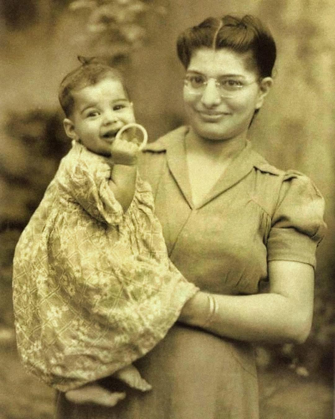 A Rare 1947 Photo Shows a Baby in His Mother's Arms — Can You Guess Which Future Rock Icon He Became?